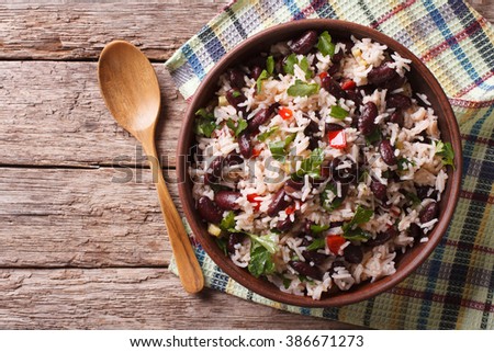 Rice with red beans and vegetables in a bowl on the table. horizontal view from above