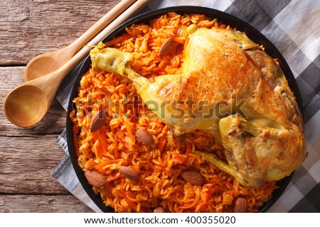Arabic Food Kabsa: chicken with rice and vegetables close-up on a plate. horizontal view from above