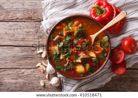 Tasty Hungarian goulash soup bograch close-up on the table and ingredients. horizontal view from above