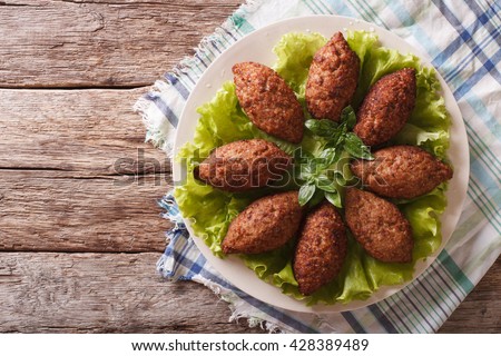 Arabic cuisine: meat appetizer kibbeh close-up on a plate. Horizontal view from above