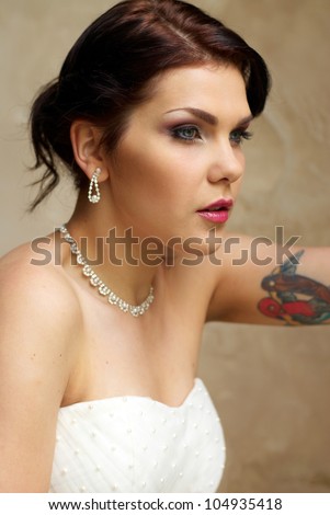 bride with tattoo posing in the room