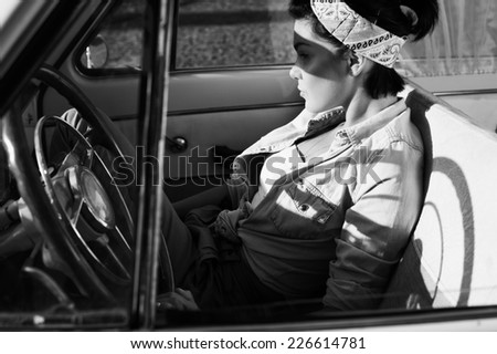 pin-up lady wearing shirt in retro car