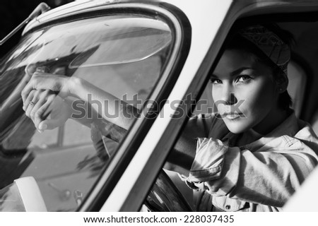 pin-up lady wearing shirt in retro car