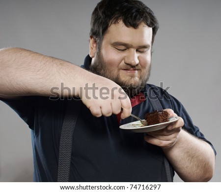 fat guy eating cake. stock photo : funny fat guy