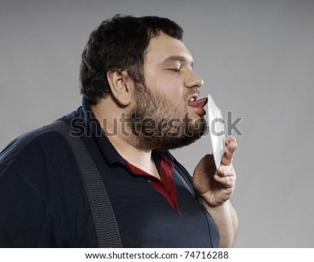 fat guy eating cheeseburger. stock photo : funny fat guy