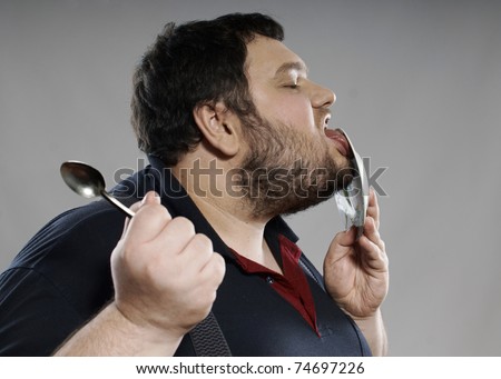 fat guy eating cake. stock photo : funny fat guy