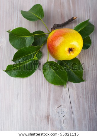 Pear on branch on wooden table