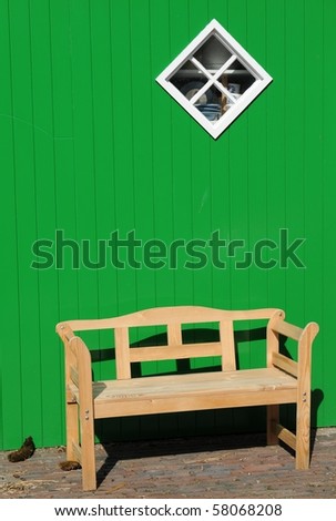Natural wood bench green wall white window