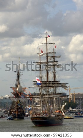 AMSTERDAM, THE NETHERLANDS - AUGUST  19: Tall ships sail in formation through the North Sea Canal on August 19, 2010 in Amsterdam, Holland. The sail parade attracts around 2 million visitors