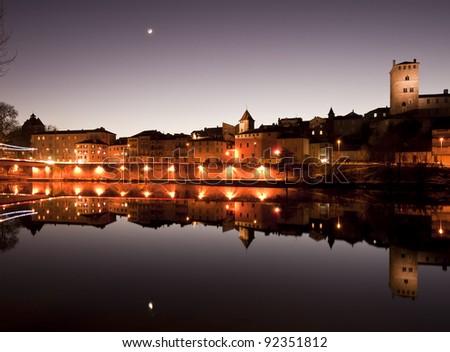 typical southern french houses reflected in water on a clear winter evening
