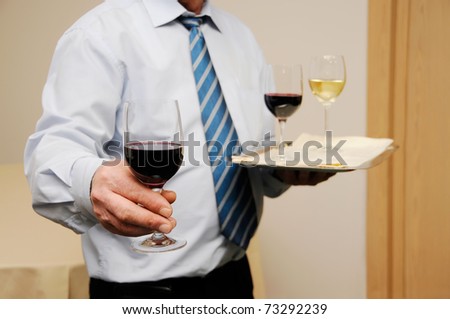 Waiter giving wine