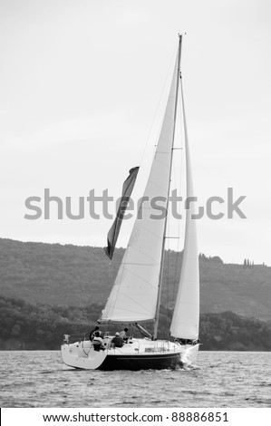 Sport sailing boat with unrecognizable persons, black and white