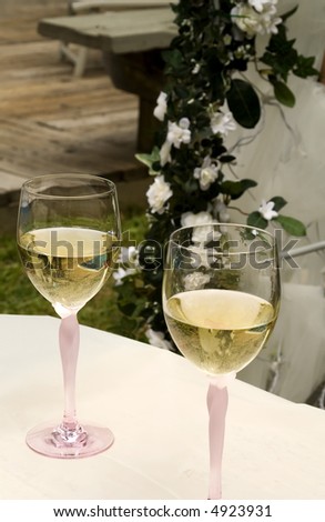 Pair of Wine Glasses with White Wine on a Wedding Table