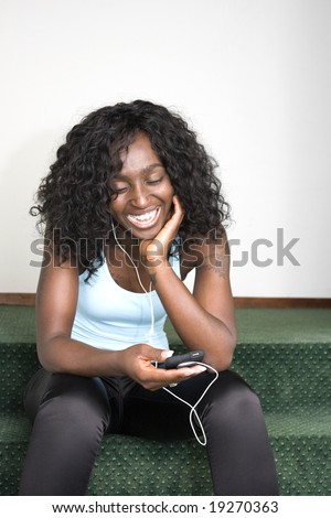  -african-american-female-sitting-down-listening-to-music-player.html 
