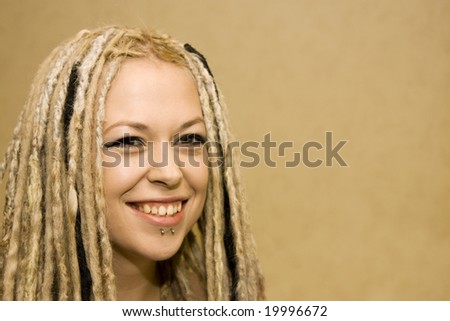 Smiling Woman with Face Piercings and Dread Lock Hair