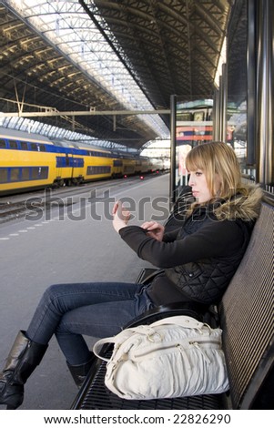 Young Woman at Train Station Looking at Watch