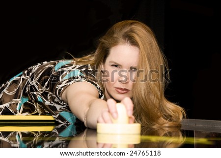 Woman with Serious Expression While Playing Air Hockey Game