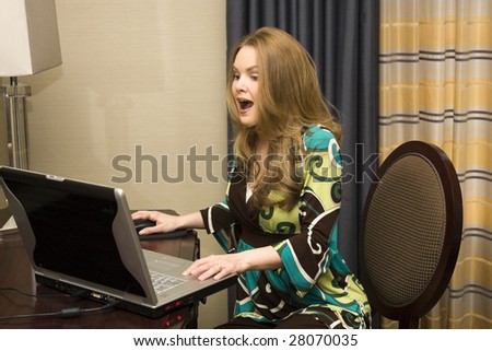 Young Female with Surprised Expression on Laptop Computer