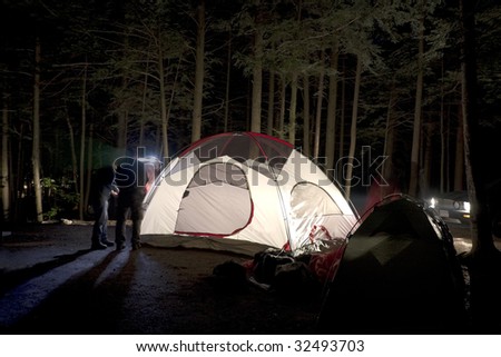 Putting Together Tent at Night on Camp Site