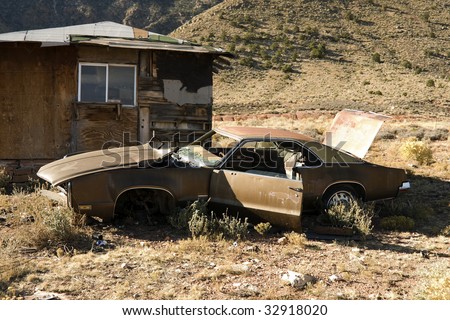 Abandoned Junk Car in Desert next to House