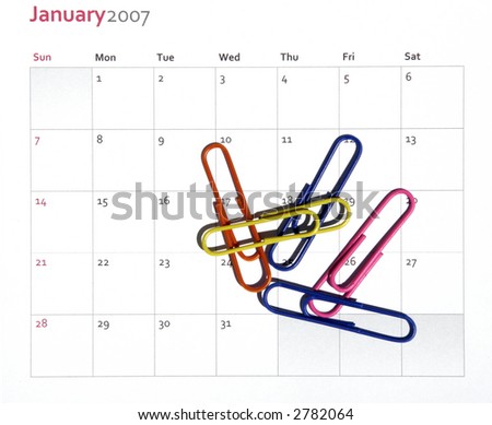 Fife Colorful Paper Clips Laying On A  Monthly Business Calendar, Background