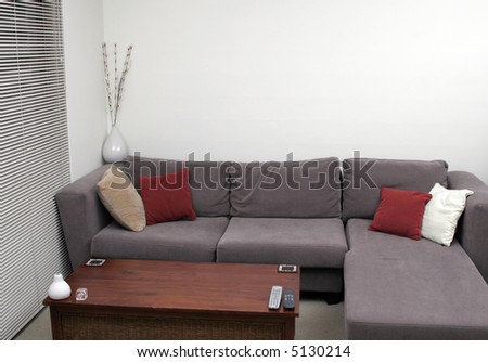 Corner Of A Living Room - Wooden Table, Sofa, Cushions