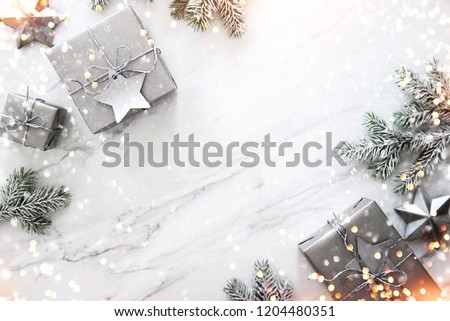 Christmas silver handmade gift boxes on white marble background top view. Merry Christmas greeting card, frame. Winter xmas holiday theme. Happy New Year. Flat lay