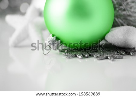 Green and silver xmas decoration on white background with copy space
