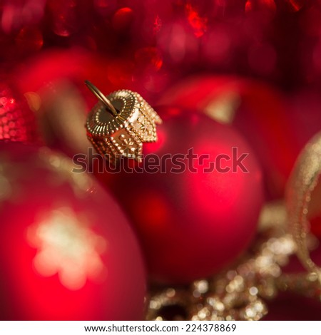 Golden and red christmas ornaments on red xmas background. Winter holiday theme.