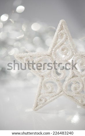 White christmas star on bokeh lights background with space for text.