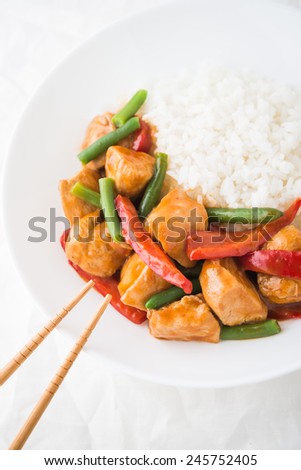 Spicy chicken with vegetables and rice top view. Oriental food.