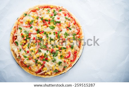 Pizza with mozzarella cheese, chicken, sweet corn, sweet pepper and parsley on white background top view. Italian cuisine. Space for text.