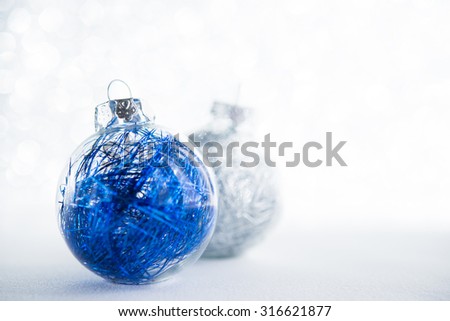 Blue and white xmas ornaments on glitter holiday background. Winter holidays. Xmas theme.
