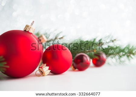 Red xmas ornaments and xmas tree on glitter holiday background. Merry christmas card. Winter holidays. Xmas theme. Happy New Year.