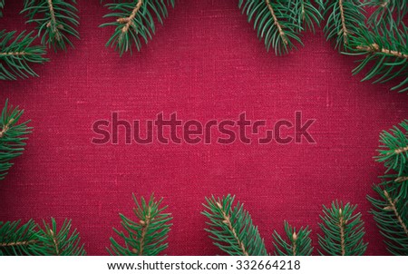 Christmas frame with xmas tree on red canvas background. Merry christmas card. Winter holidays. Xmas theme. Space for text. Happy New Year.