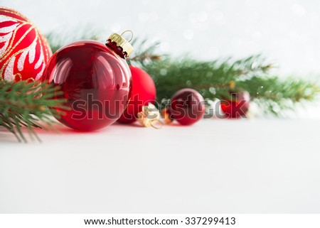 Red xmas ornaments and xmas tree on white wooden background. Merry christmas card. Winter holidays. Xmas theme. Happy New Year.