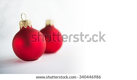 Red christmas ornaments on glitter holiday background. Winter holidays. Xmas theme. Space for text. Happy New Year.