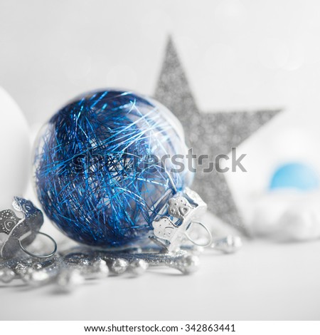 Blue and white xmas ornaments on glitter holiday background. Merry christmas card. Winter holidays. Xmas theme. Happy New Year.