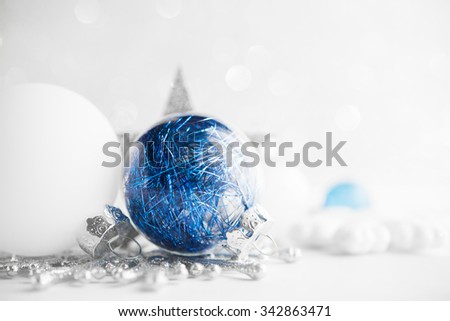 Blue and white xmas ornaments on glitter holiday background. Merry christmas card. Winter holidays. Xmas theme. Happy New Year.