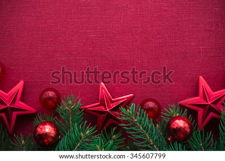 Christmas frame with xmas tree and ornaments on red canvas background. Merry christmas card. Winter holidays. Xmas theme. Space for text. Happy New Year.