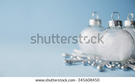 White xmas ornaments on light blue background. Merry christmas card. Winter holidays. Xmas theme. Space for text. Happy New Year.
