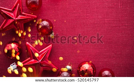 Christmas background with red ornaments and sparkle bokeh lights on red canvas background. Merry christmas card. Winter holiday theme. Space for text. Happy New Year.