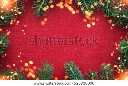 Christmas background with xmas tree and sparkle bokeh lights on red canvas background. Merry christmas card. Winter holiday theme. Happy New Year. Space for text