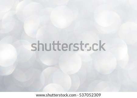 Unfocused abstract silver white glitter bokeh holiday background. Winter xmas holidays. Christmas.