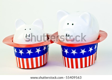 Two patriotic piggy banks sitting inside of stars and stripes hats on a white background.