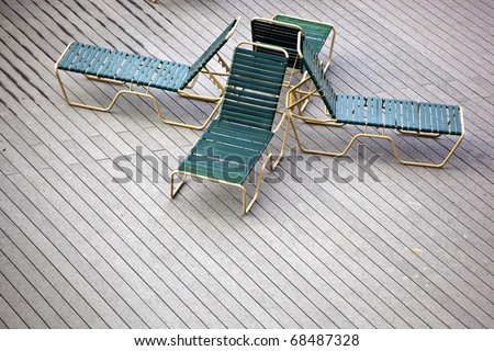 four back to back lounge chairs on a deck