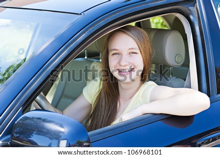 Teenage female driving student learning to drive a car