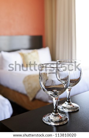 Romantic bedroom with wine glasses in luxury hotel interior