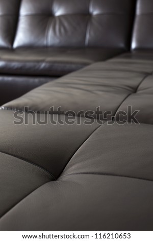 Closeup of luxurious expensive black leather couch