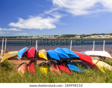 Colorful kayaks stored on Atlantic shore in North Rustico, Prince Edward Island, Canada
